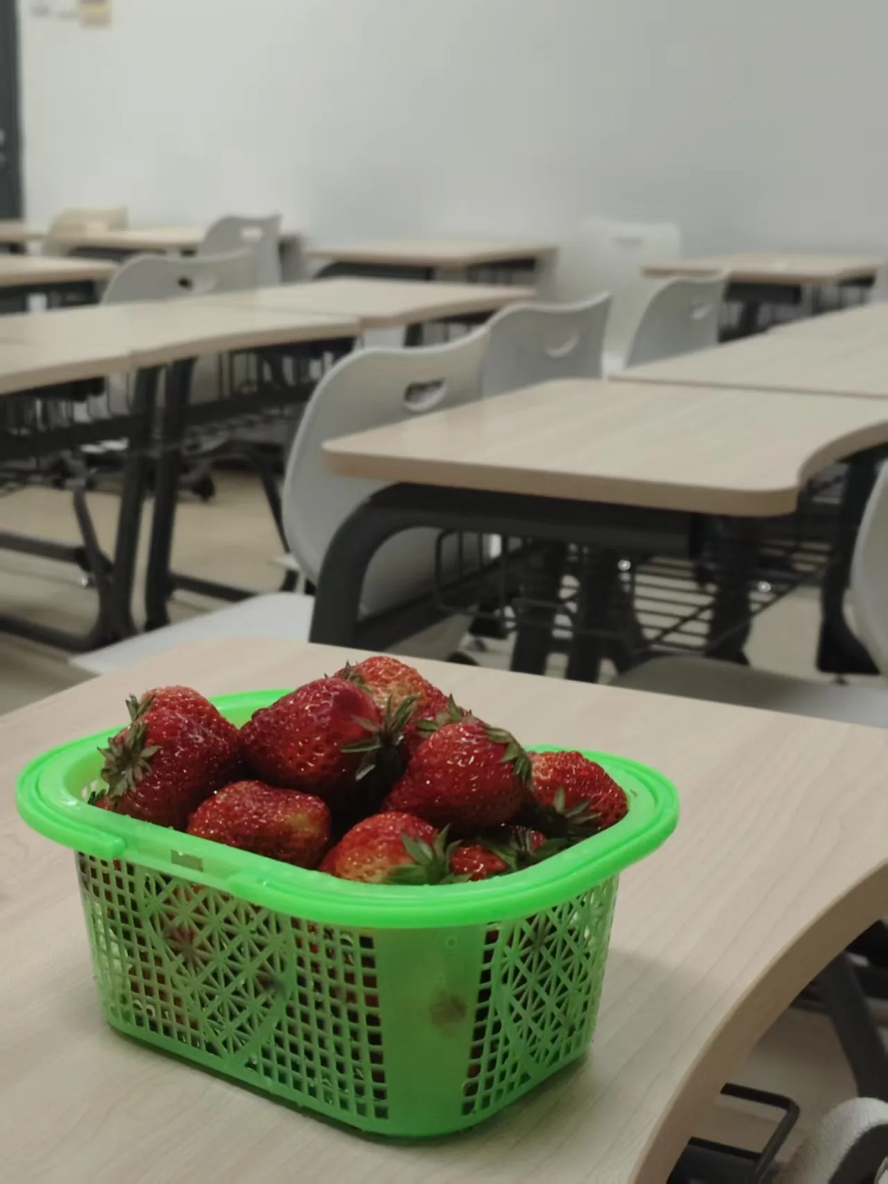 Red strawberries in a green basket