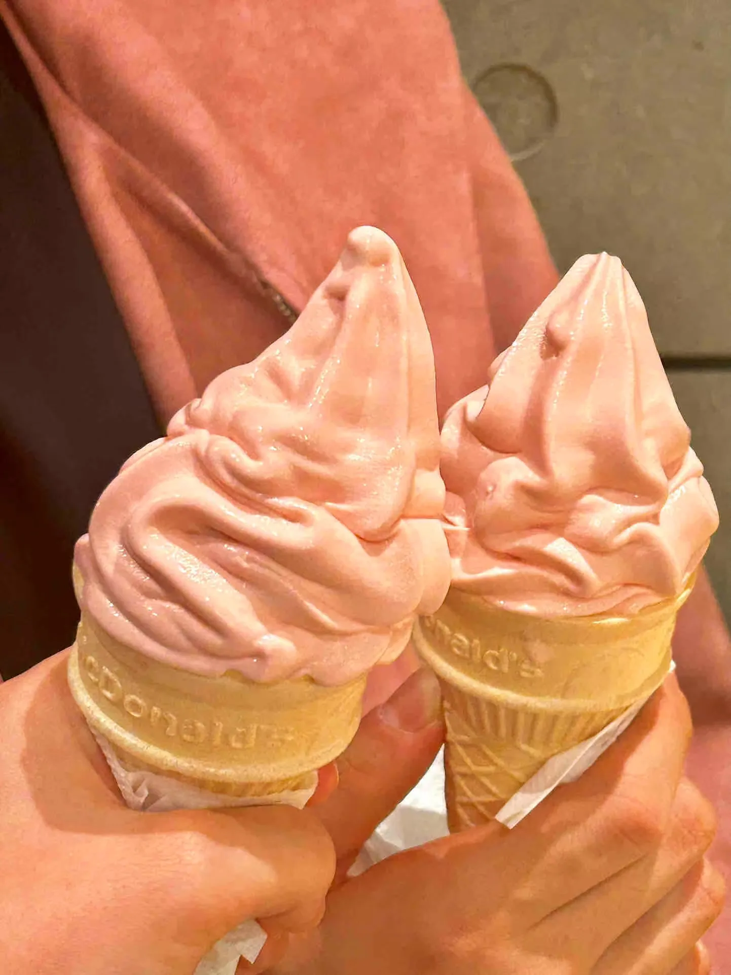 A pink strawberry ice cream cone